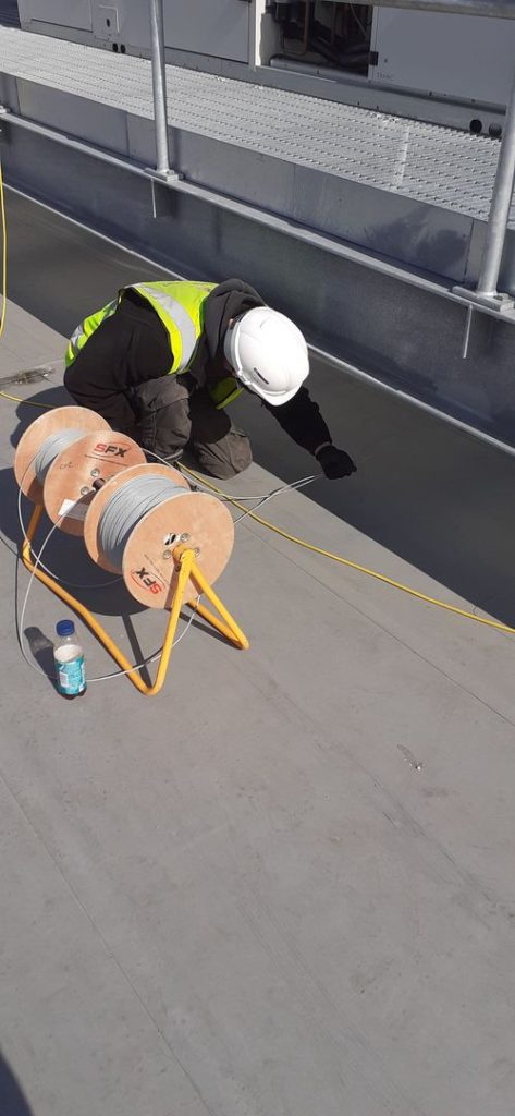Electrician rewiring a warehouse