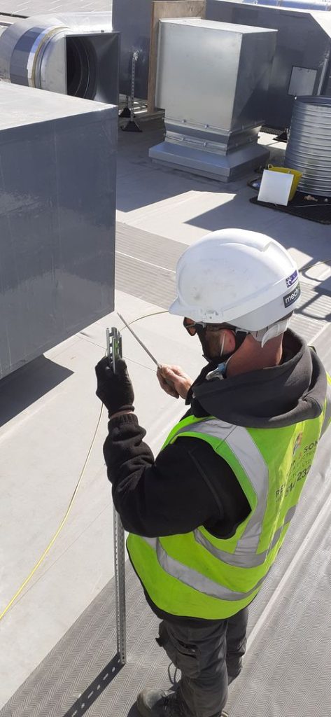 electrician rewiring an industrial building